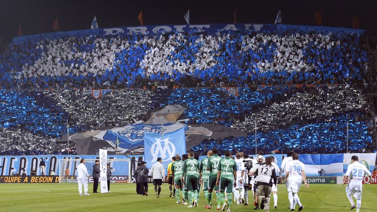 Marseille and Saint-Etienne teams arrive on the field prior to their French L1 football match Olympique de Marseille (OM) vs. Saint-Etienne, on April 25, 2