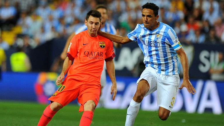 Barcelona's Lionel Messi vies with Malaga's Brazilian defender Weligton