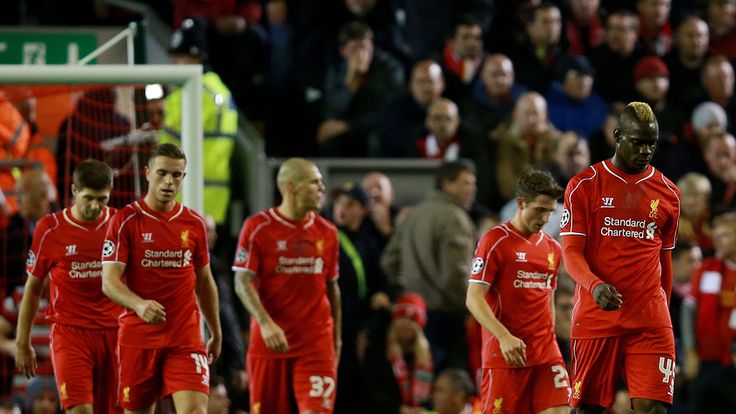 Liverpool players make their way back to the centre spot after conceding their third goal 