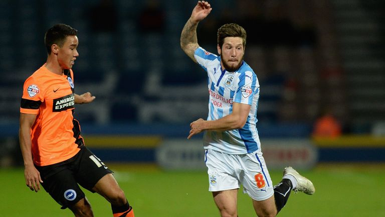 Huddersfield's Jacob Butterfield (right) vies with Adam Chicksen of Brighton