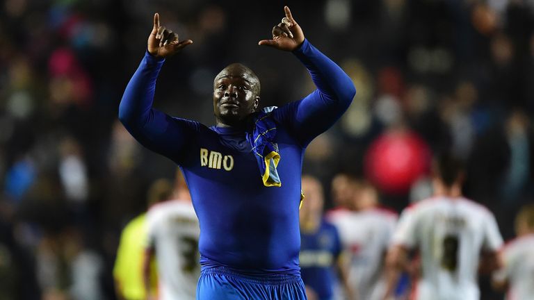 Adebayo Akinfenwa of AFC Wimbledon celebrates victory during the Johnstone's Paint Trophy Southern Section