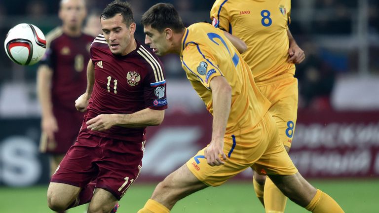 Russia's forward Aleksandr Kerzhakov fights for the ball with Moldova's midfielder Artur Ionita