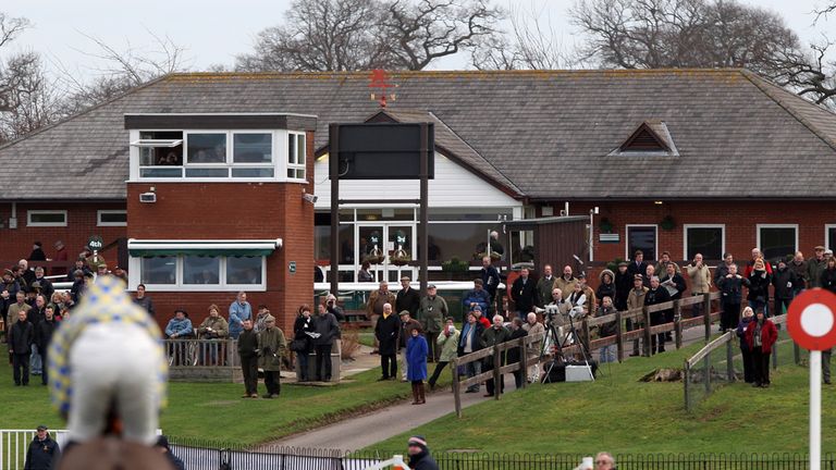 A general view of crowds watching the action at Bangor-On-Dee Racecourse