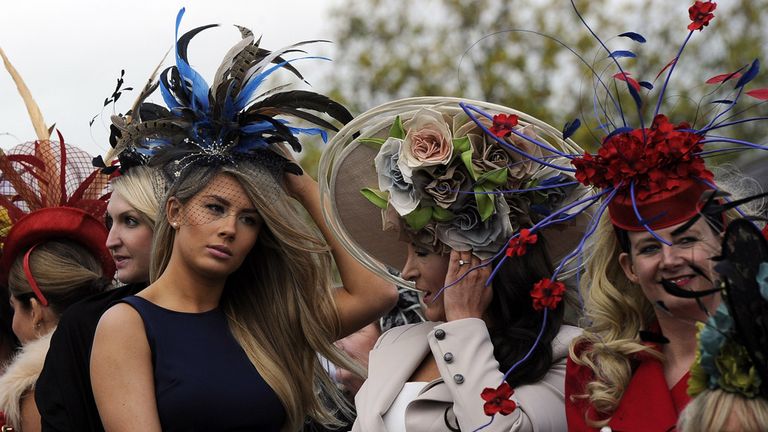 Contestants hold onto their hats while waiting to be judged in the Best Dressed Lady of 2014 Final
