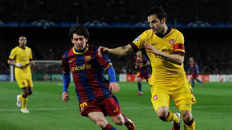 Lionel Messi of Barcelona duels for the ball with Cesc Fabregas of Arsenal during the UEFA Champions League round of 16 