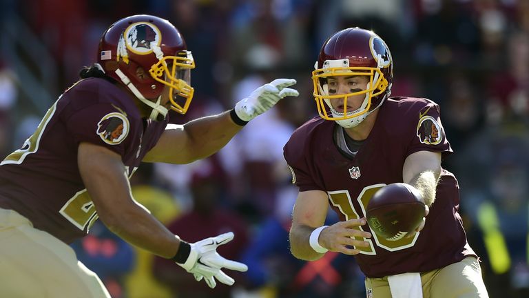 Colt McCoy of the Washington Redskins hands off to Roy Helu during their game against the Tennessee Titans