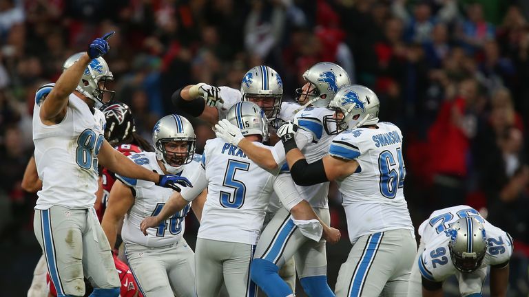  Matt Prater #5 of the Detroit Lions celebrates with team mates  at Wembley