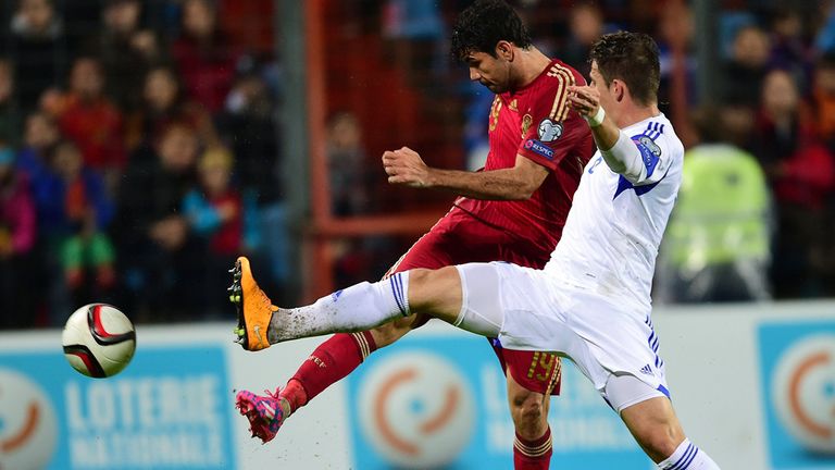 Spain's Diego Costa vies with Luxembourg's Chris Philipps 