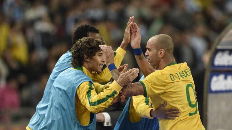 Diego Tardelli is congratulated by his Brazil team-mates after scoring a goal during the Superclasico match against versus Argentina in Beijing