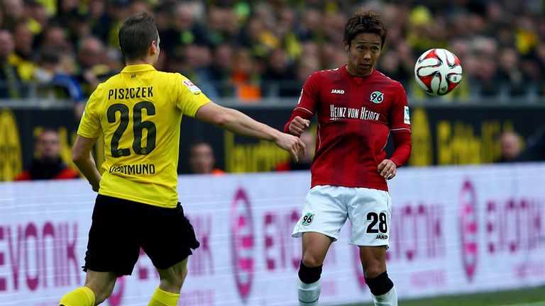 DORTMUND, GERMANY - OCTOBER 25:  (L-R) Lukasz Piszczek of Dortmund challenges Horoshi Kiyotake of Hannover 