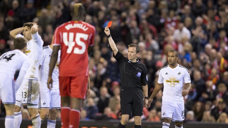 Swansea City's Argentinian defender Federico Fernandez (2nd L) is given a red card during the Capital One Cup Fourth Round football match at Liverpool