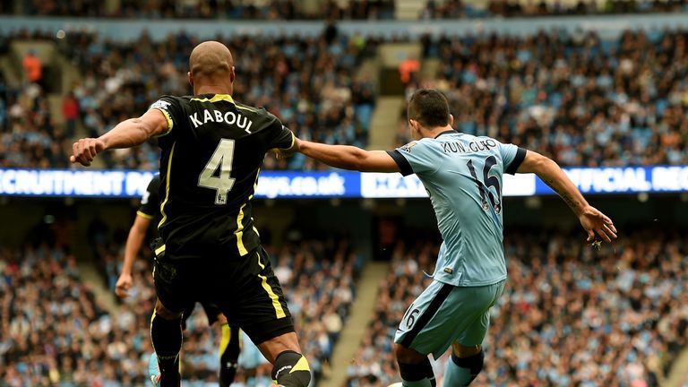 Sergio Aguero shoots past Younes Kaboul to score the opening goal - City go 1-0 up