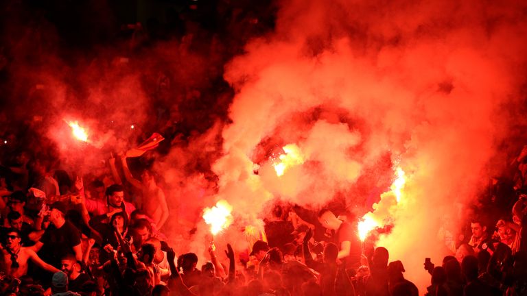 Galatasaray supporters are livelier than their side as several flares are thrown onto the pitch
