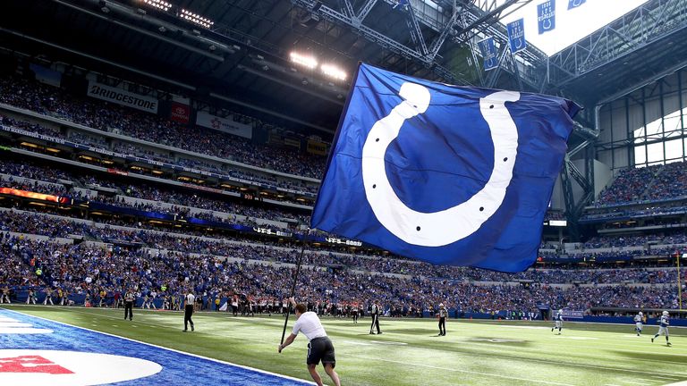 A cheerleader waves a flag during the game against the Cincinnati Bengals at Lucas Oil Stadium