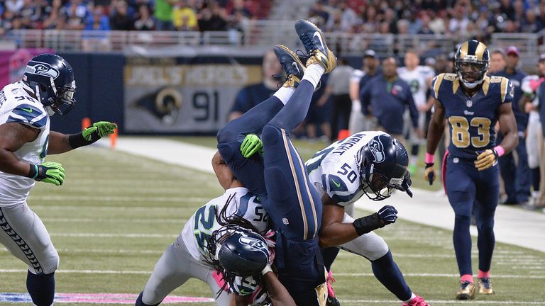 Richard Sherman of the Seattle Seahawks tackles Jared Cook of the St. Louis Rams in the fourth quarter