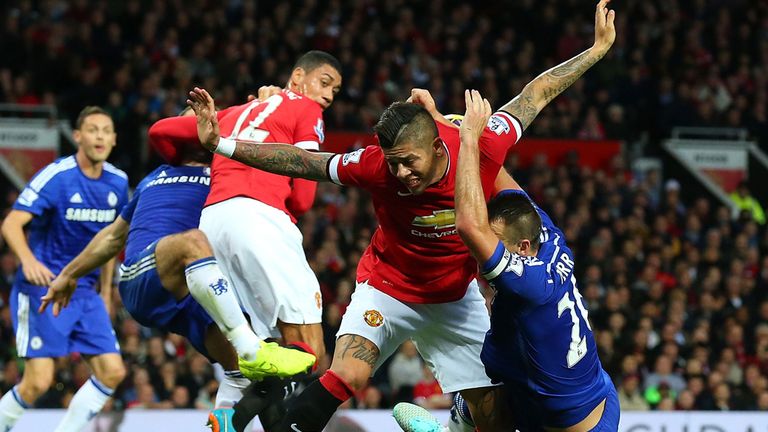 John Terry tangles in the penalty area with Marcos Rojo