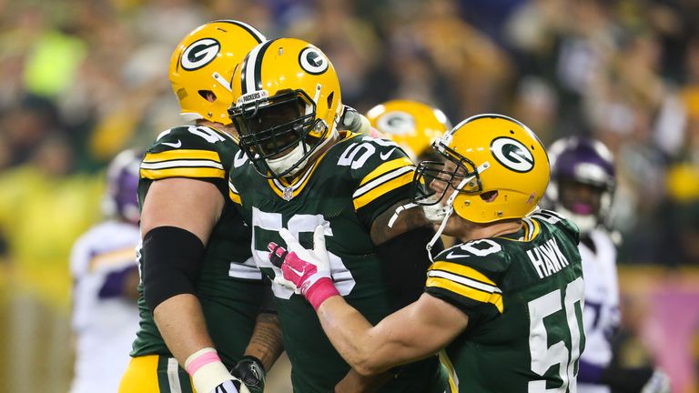 Julius Peppers of the Green Bay Packers celebrates with A.J. Hawk after scoring a touchdown against the Minnesota Vikings