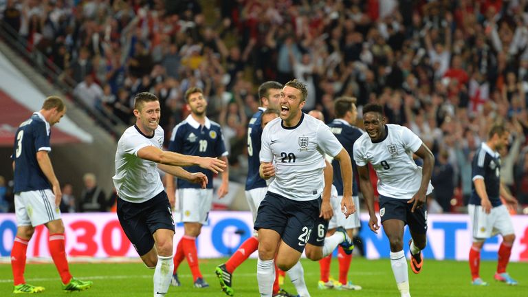 LONDON, ENGLAND - AUGUST 14: Rickie Lambert of England (C) celebrates with teammates Gary Cahill of England (L) and Danny Welbeck of England (R) after sc