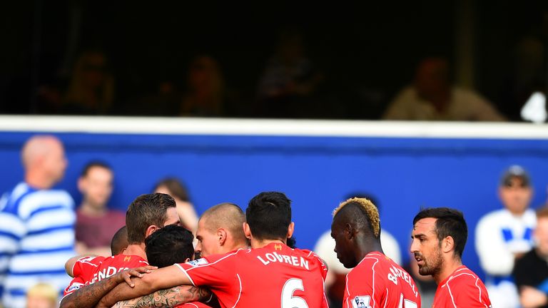 LONDON, ENGLAND - OCTOBER 19:  Liverpool players celebrate after Richard Dunne of QPR scored an own goal during the Barclays Premier League match between Q