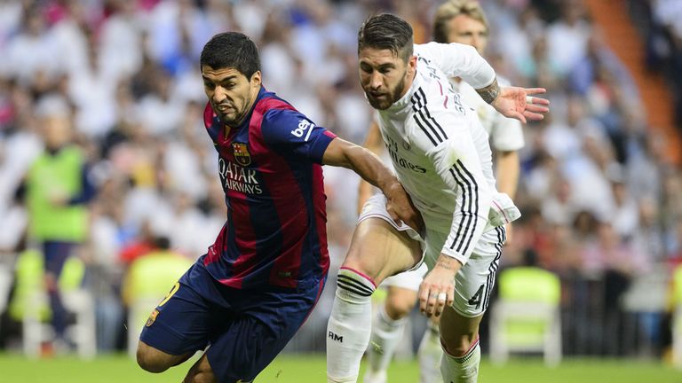 Barcelona's Luis Suarez vies with Sergio Ramos