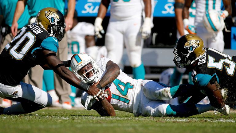 Miami Dolphins wrestled their way to a 27-13 triumph over the Jacksonville Jaguars