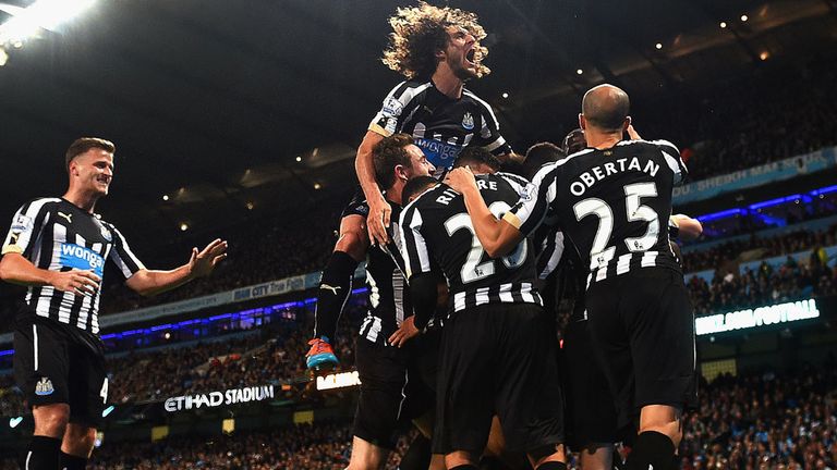 Moussa Sissoko of Newcastle United  is mobbed by team mates