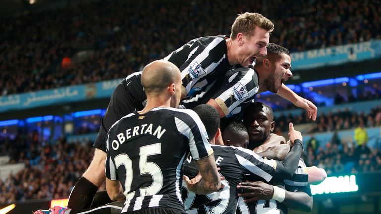 Newcastle United's Moussa Sissoko (obscured) is mobbed by team-mates after scoring their second goal of the game during the Capital One Cup Fourth Round