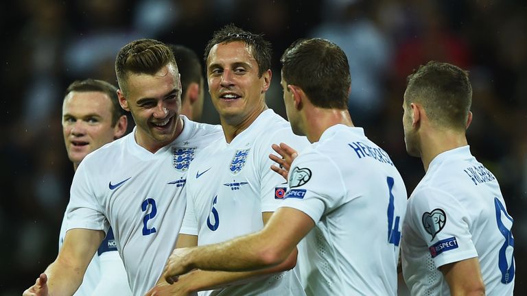 Phil Jagielka of England (6) celebrates with team mates Calum Chambers (2) and Jordan Henderson (4) as he scores their first goal against San Marino