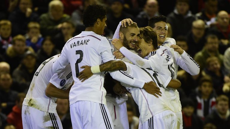Real Madrid forward Karim Benzema celebrates with team-mates after scoring Real Madrid's third goal against Liverpool