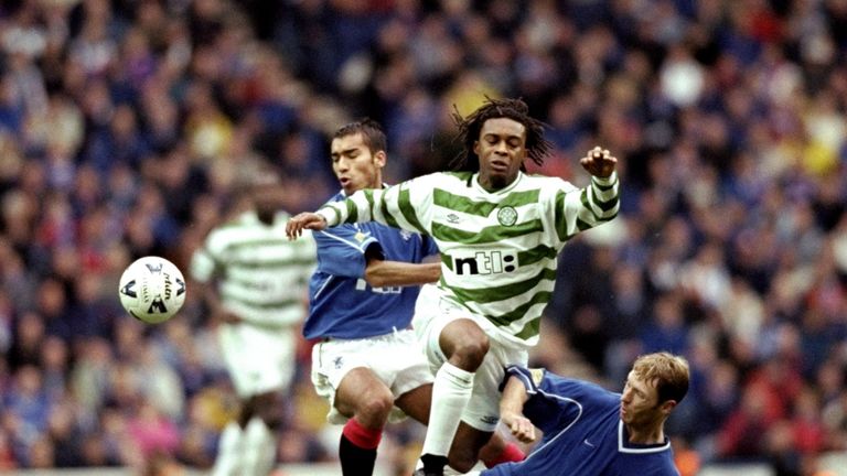 7 Nov 1999:  Regi Blinker of Celtic is foiled by Giovanni van Bronckhorst and Craig Moore of Rangers in the Scottish Premier League match at Ibrox in Glasg