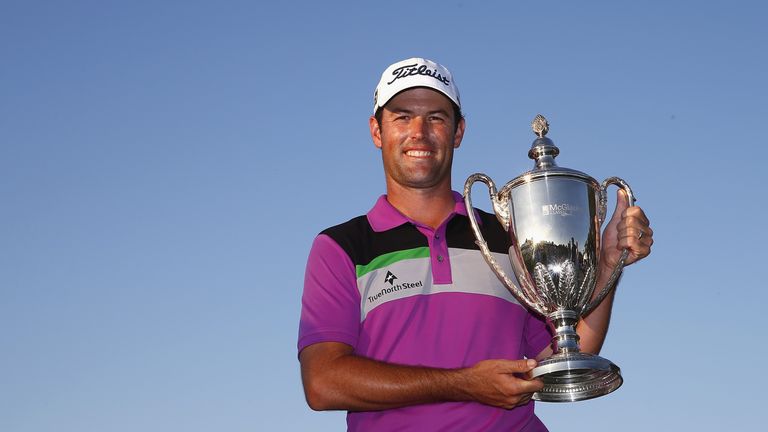 Robert Streb poses with the winner's trophy after winning The McGladrey Classic