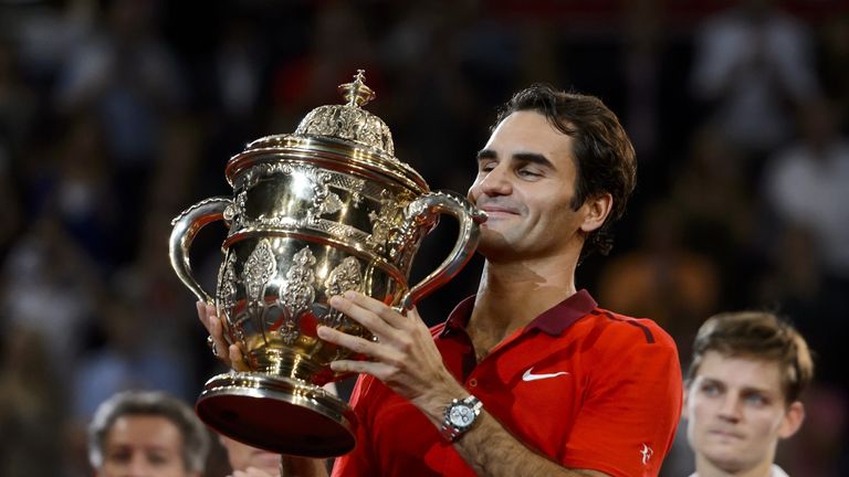 Roger Federer of Switzerland raises the trophy after he won his final match against David Goffin of Belgium at the Swiss Indoors ATP tennis tournament