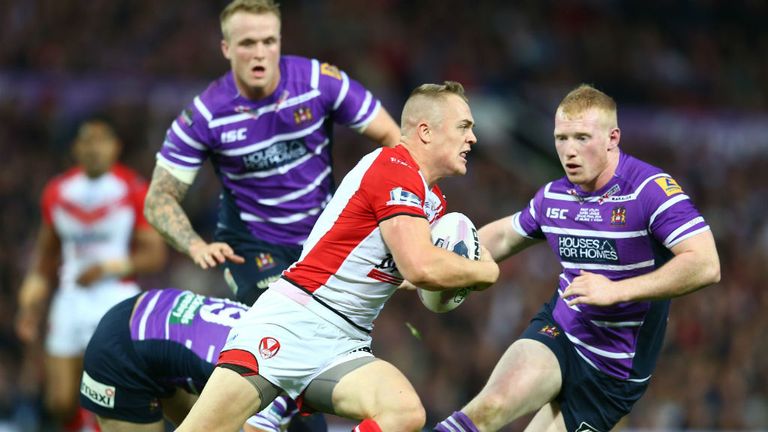 Adam Swift (C) of St Helens is tracked by Liam Farrell (R) of Wigan during the First Utility Super League Grand Final
