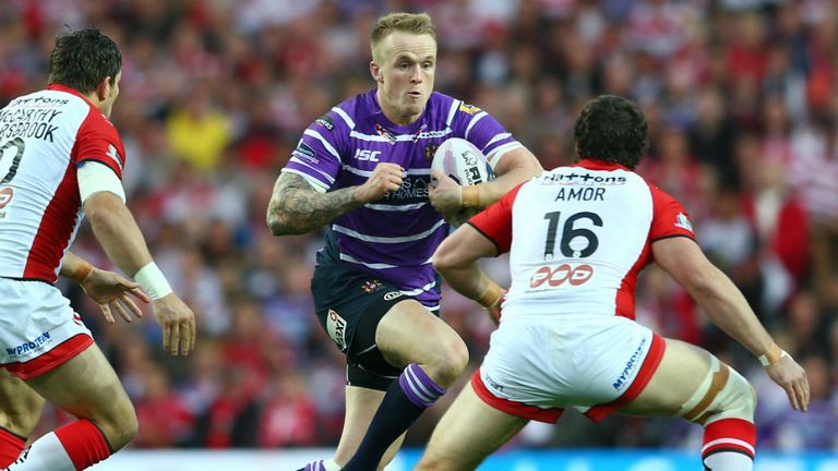 Dominic Crosby of Wigan runs at Kyle Amor of St Helens during the Super League Grand Final