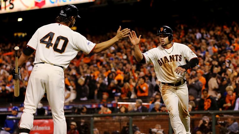 Juan Perez celebrates with Madison Bumgarner of the San Francisco Giants after scoring in the eighth inning against Kansas 