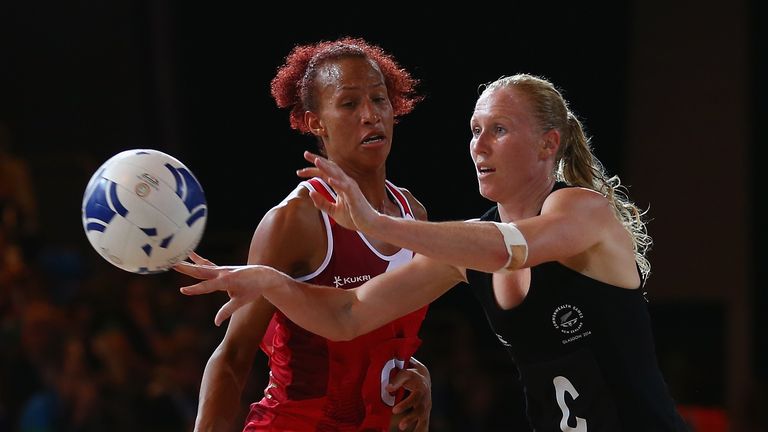 GLASGOW, SCOTLAND - AUGUST 02: Laura Langman of New Zealand releases the ball as she is pressured by Serena Guthrie of England during the netball semi fina