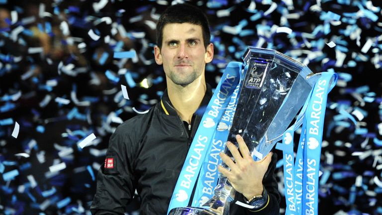 Novak Djokovic poses with the winners' trophy after the 2012 ATP World Tour final against Roger Federer