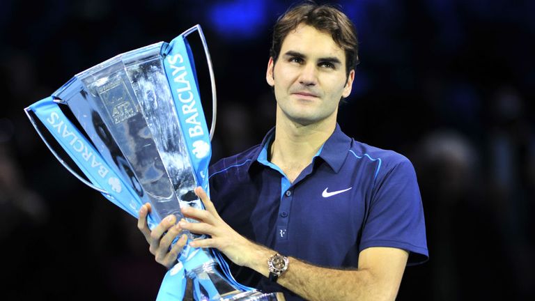 Roger Federer poses with the ATP World Tour Finals trophy after beating Jo-Wilfried Tsonga in the 2011 final