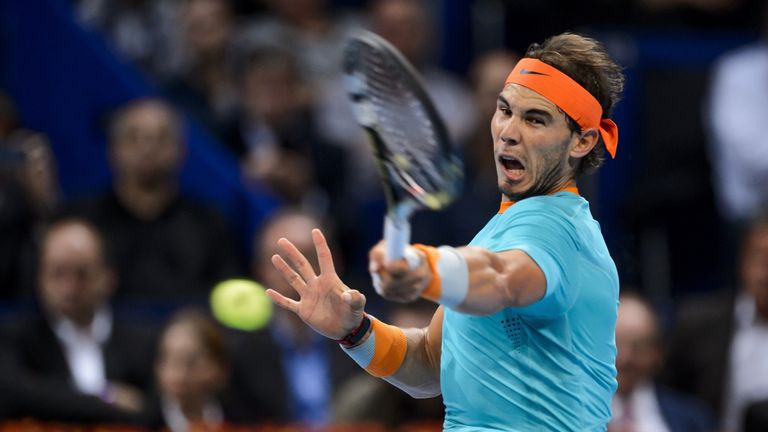 Rafael Nadal of Spain returns a ball to Pierre-Hugues Herbert of France during the Swiss Indoors in Basel. 