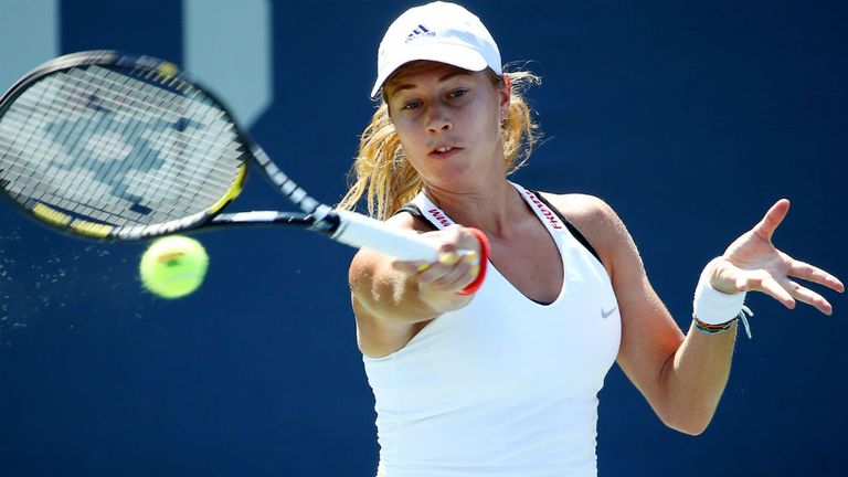 Stefanie Voegele returns a shot to Saisai Zheng during their women's first round match at the 2014 US Open