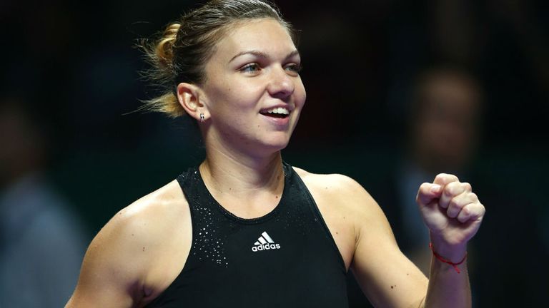 Simona Halep celebrates against Eugenie Bouchard in their round robin match of the WTA Finals in Singapore