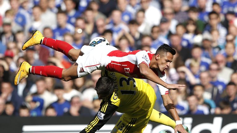 Arsenal's Chilean striker Alexis Sanchez collides with Thibaut Courtois, which results with the keeper being substituted