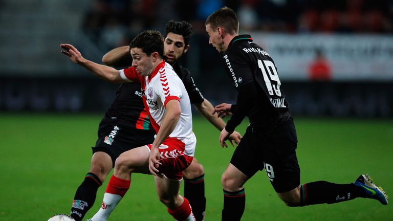 Tommy Oar of Utrecht battles for the ball with Marnick Vermijl (R) and Alireza Jahanbakhsh of NEC during the Dutch Eredivisie game