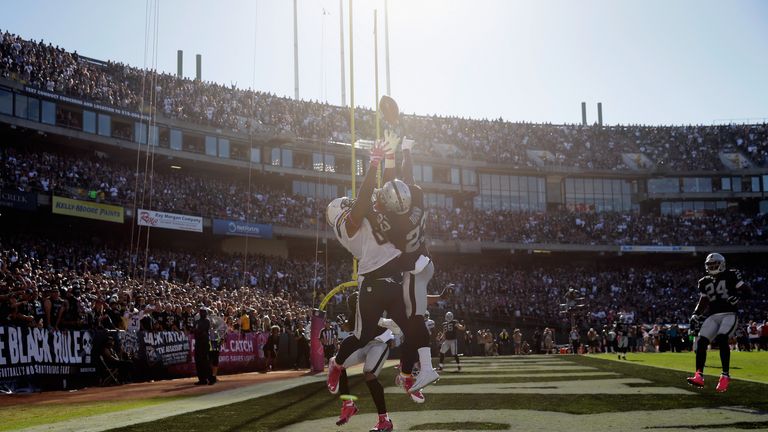 Antonio Gates of the San Diego Chargers battles for a catch against the Oakland Raiders in week six of the NFL season