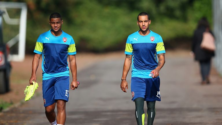 Theo Walcott (R) of Arsenal walks out for training alongside Serge Gnabry (L) during an Arsenal training session