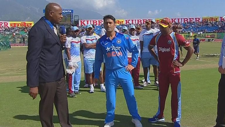 West Indies players line up in solidarity behind Dwayne Bravo (right) at the toss