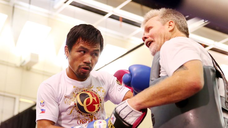 MACAU - NOVEMBER 20:  Manny Pacquiao works the mitts with trainer Freddie Roach during a workout session at The Venetian on November 20, 2014 in Macau, Mac