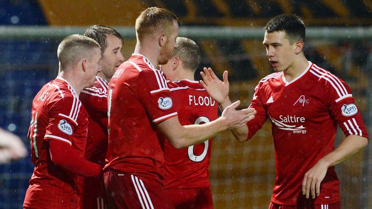 The Aberdeen players celebrate after Ross County's Paul Quinn turns in a own goal