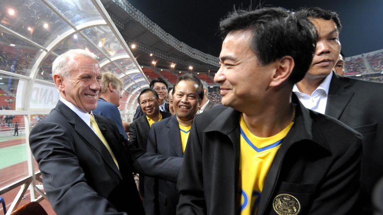 Thai Prime Minister Abhisit Vejjajiva (R)with Thai football coach Peter Reidduring the AFF Suzuki Cup 2008 football final round first leg in Bangkok