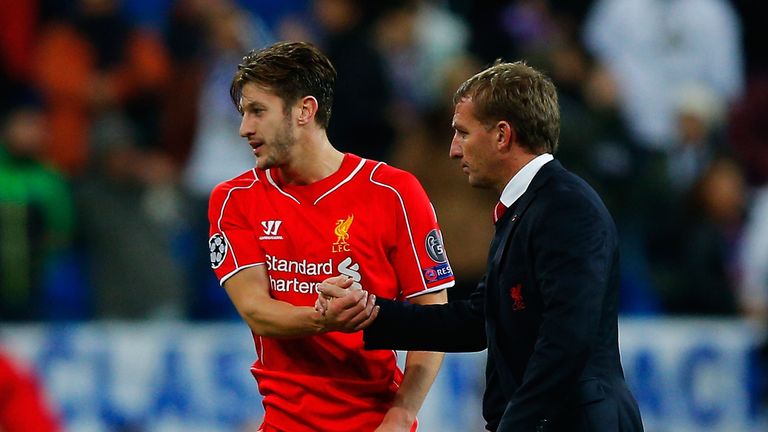 Adam Lallana (L) of Liverpool FC shakes hands with his head coach Brendan Rodgers (R) after the UEFA Champions League Group B clash at Real Madrid
